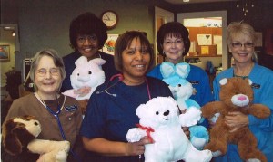 HACH staff holding teddy bears